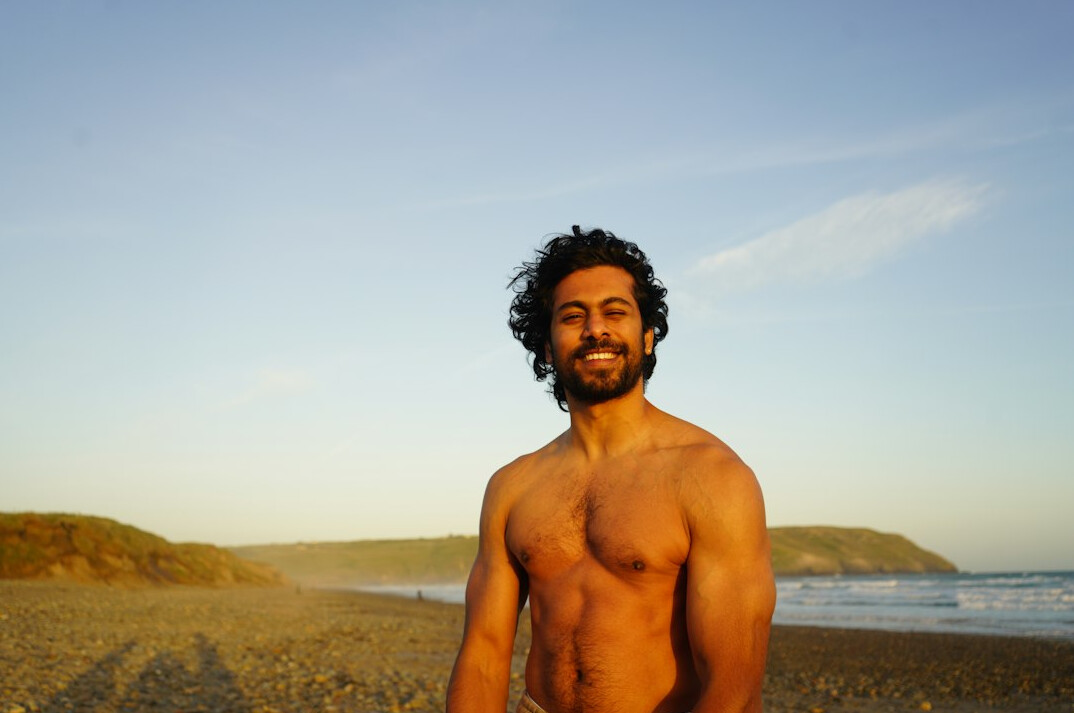 Studio portrait of a Brazilian man with a beard smiling