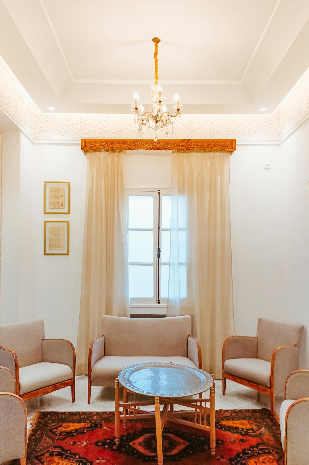 Group of people sitting together talking in a bright living room