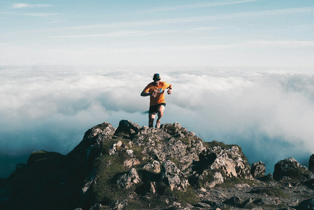 person achieving goals outdoors